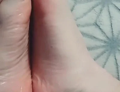 Guy Gently Massages His Feet with Oil