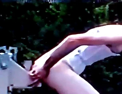 Crossdresser Riding a Giant Dildo on a Roof Top