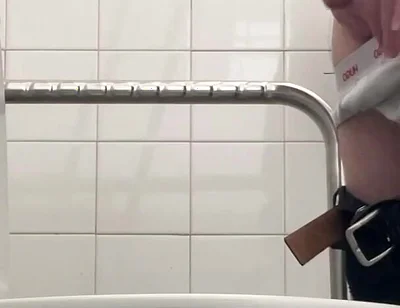 In the Hospital Toilets, a Guy Pisses Into a Cup for a Urine Sample, Then Gets Horny, Jerks-off and Cums