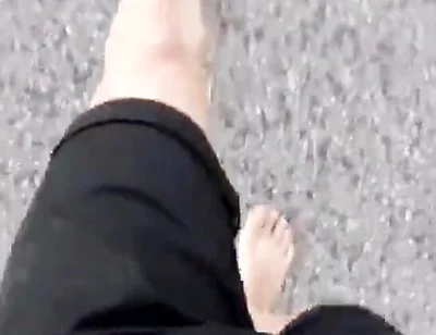 Jon Arteen Walks Barefoot on the Street Outdoors, the Boy Is Barefoot in the Crowded Tram to the Town Center