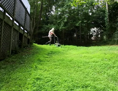 Big Fake Tits Crossdresser in Daisy Dukes Mowing Grass