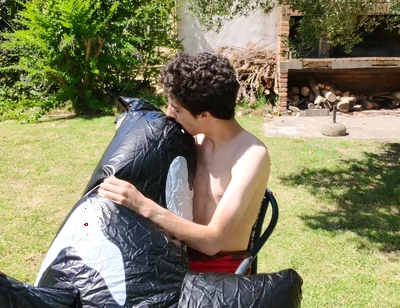Beautiful Man Inflates His Inflatable Whale Near Pool Outside