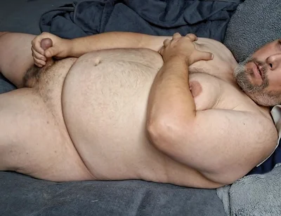 Chubby Guy Lays in Bed and Cums