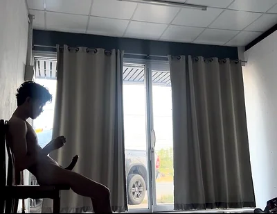 A Handsome Young Man Jerks off in Front of a Glass Door