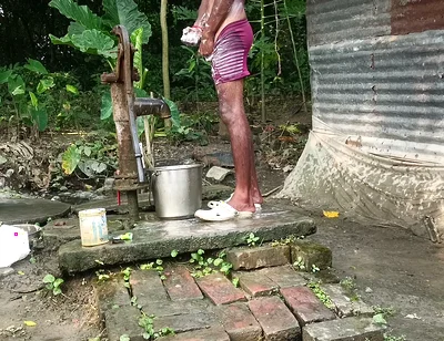 Black mature man bath in desi style. Showing big dick.